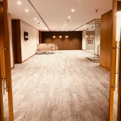 Neutral, well-lit education center hallway with wooden frames, glass doors, and a sign reading 'EDUCATION CENTRE' on the left.